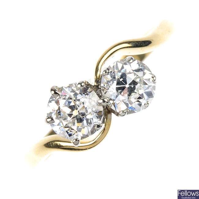 An 18ct gold diamond two-stone ring. 