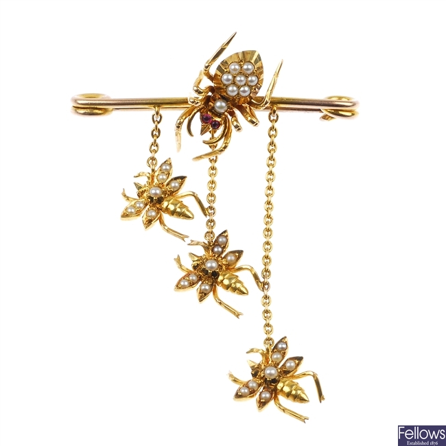 An early 20th century gold split pearl spider and fly bar brooch.