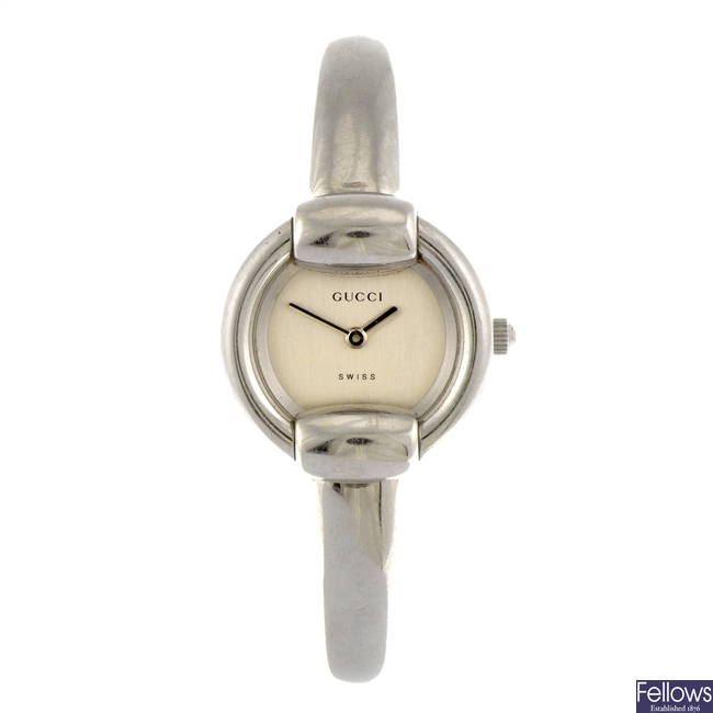 A stainless steel quartz lady's Gucci 1400L bangle watch.