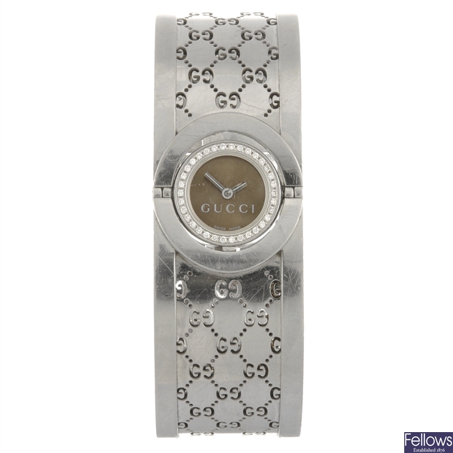 (304293296) A stainless steel quartz lady's Gucci Twirl bangle watch.