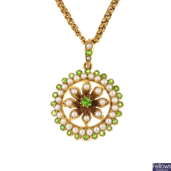 An early 20th century 15ct gold demantoid garnet and split pearl pendant.