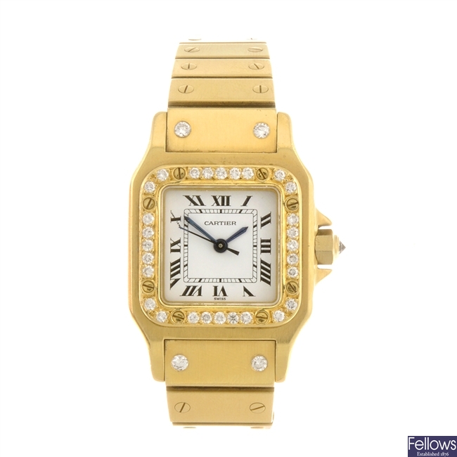 An 18k gold automatic Cartier Santos bracelet watch.