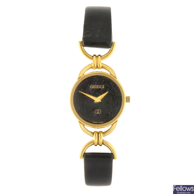 A gold plated quartz lady's Gucci 6000L wrist watch.