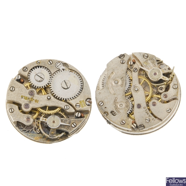 A group of watch movements and parts.
