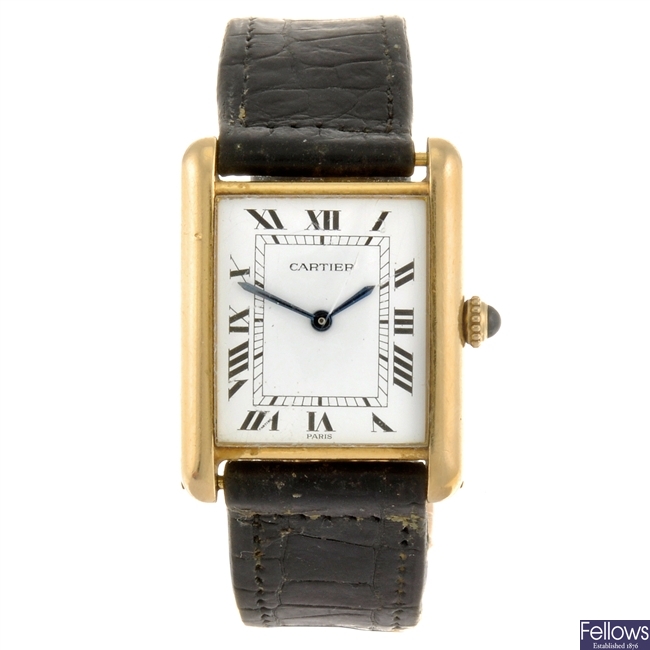 An 18k gold manual wind Cartier Tank wrist watch.