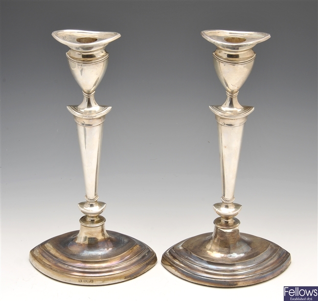 An Edwardian pair of silver candlesticks.