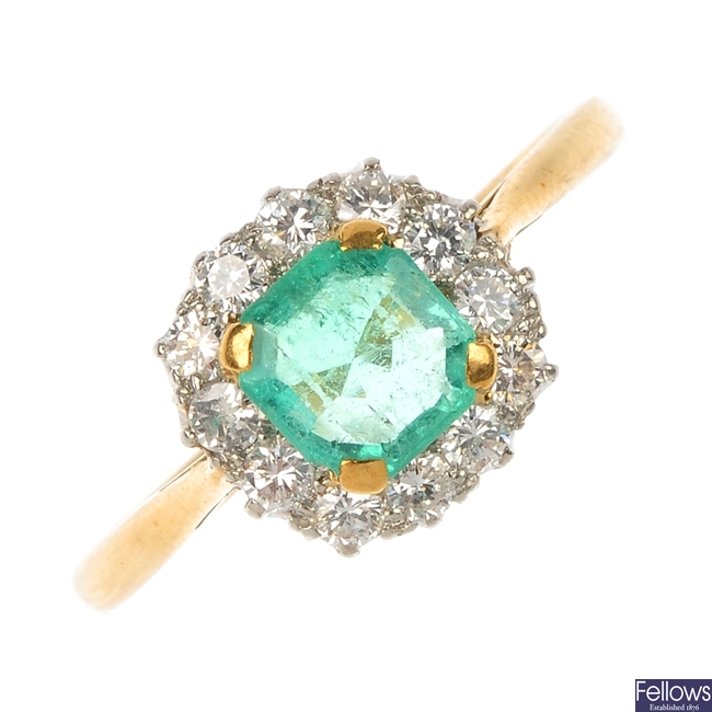 A mid 20th century 18ct gold and platinum emerald and diamond cluster ring.