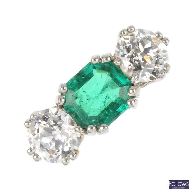 A mid 20th century platinum emerald and diamond ring.