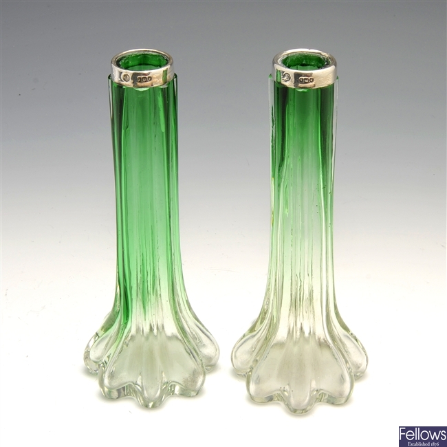 An Edwardian pair of silver mounted green glass vases.