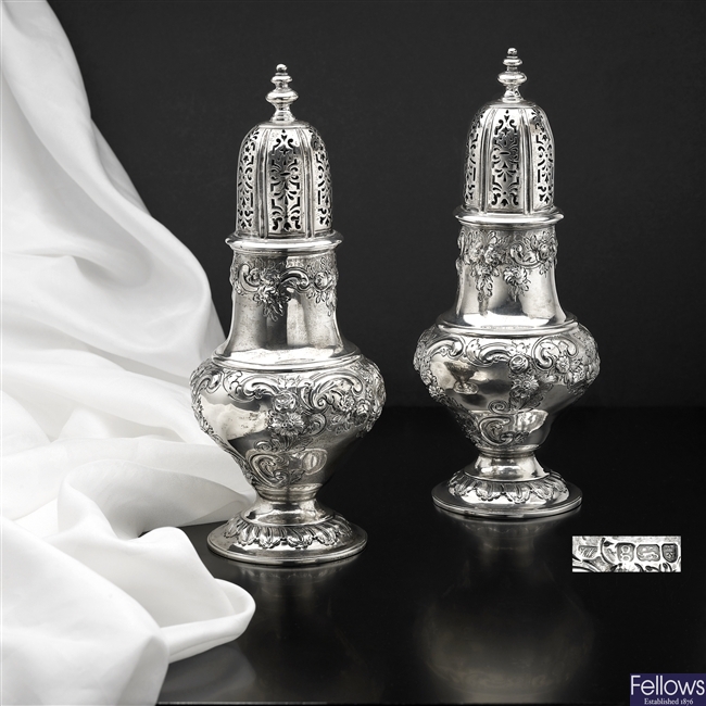 A pair of George III large silver casters.