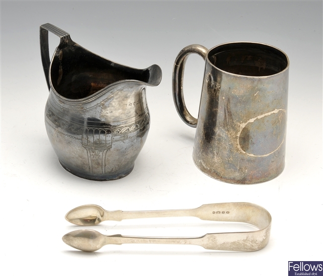 A George III cream jug, Victorian christening mug & Victorian pair of sugar tongs.