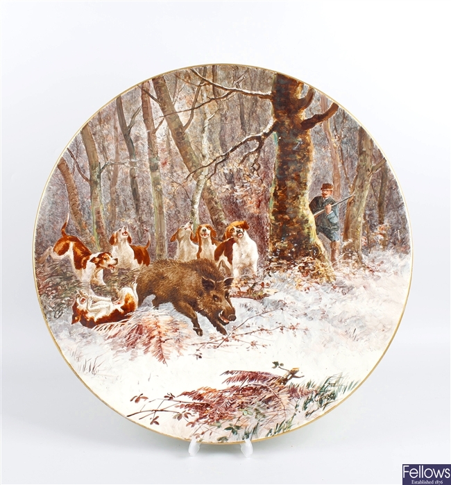 A large pottery charger painted with a boar hunt
