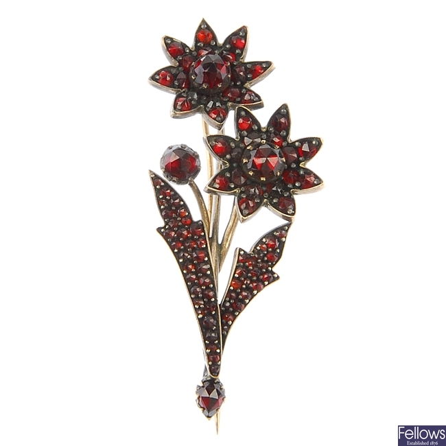 A late 19th century garnet and red paste floral brooch.