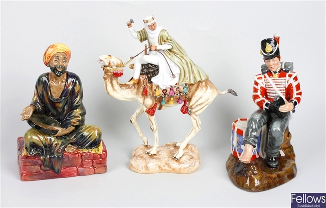 A box containing various Royal Doulton figurines
