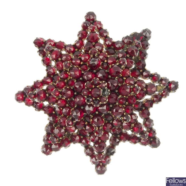 A late 19th century red paste star brooch. 