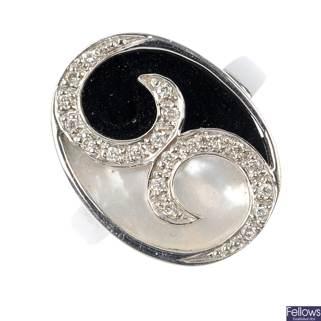 An 18ct gold onyx, mother-of-pearl and diamond dress ring. 