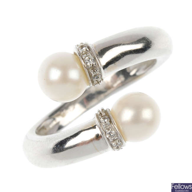 A cultured pearl and cubic zirconia crossover ring. 
