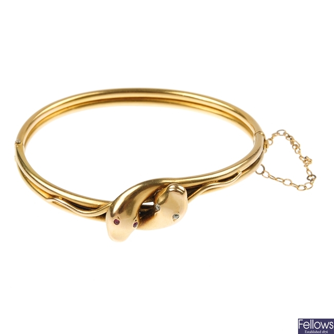 A late 19th century 15ct gold diamond and paste snake bangle.