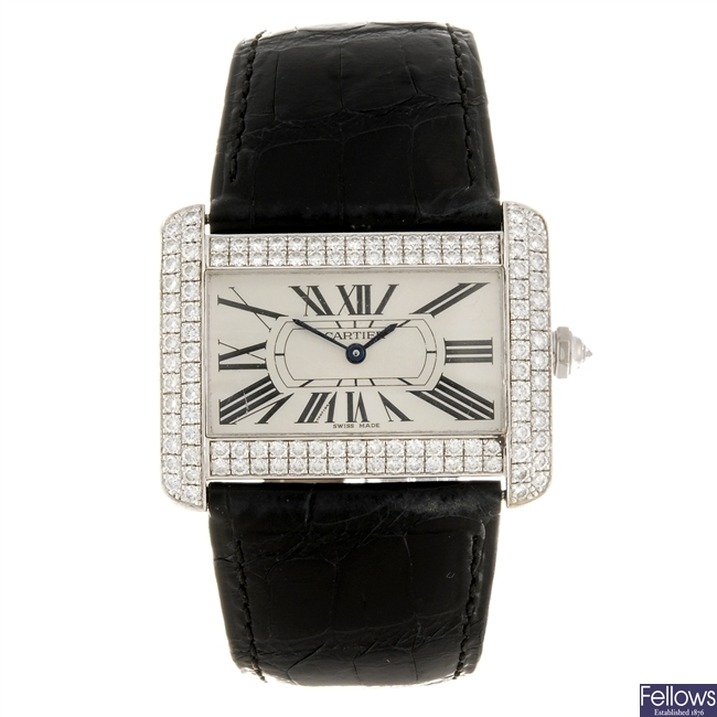 An 18k white gold quartz Cartier Tank Divan wrist watch.