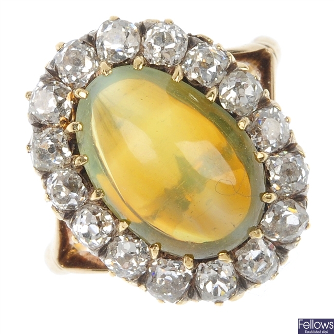 A late 19th century gold cats-eye chrysoberyl and diamond cluster ring.
