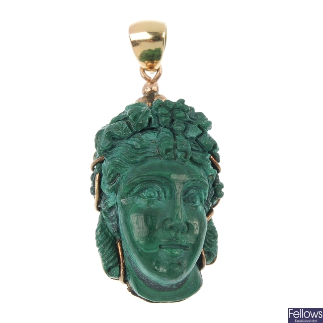 A carved malachite pendant.