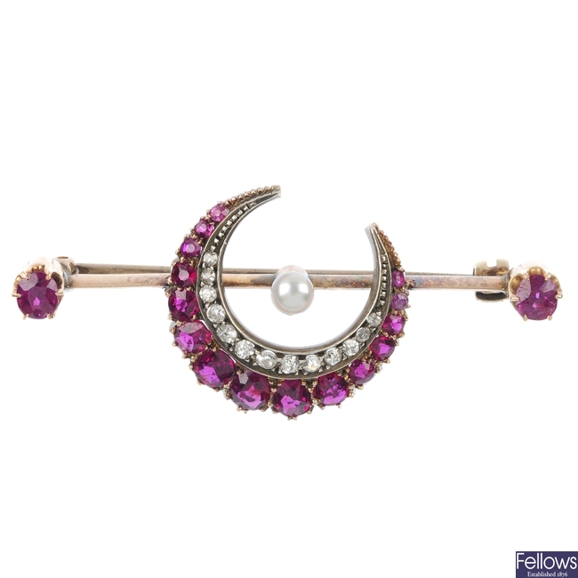 A late Victorian 15ct gold ruby and diamond crescent brooch, circa 1880.