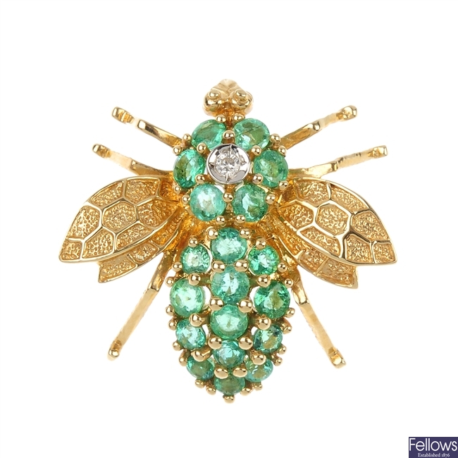 An emerald and diamond fly brooch.