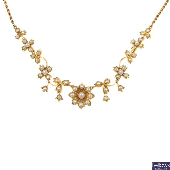 An early 20th century gold split pearl floral necklace.