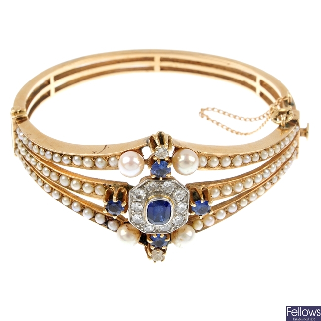 A mid 20th century continental gold diamond, synthetic sapphire, sapphire and split pearl bangle.