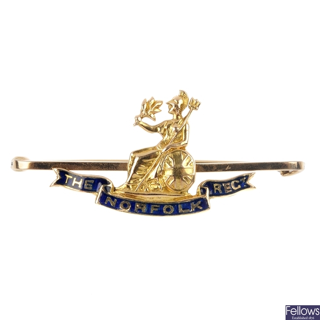 An early 20th century 15ct gold Norfolk Regimental bar brooch.