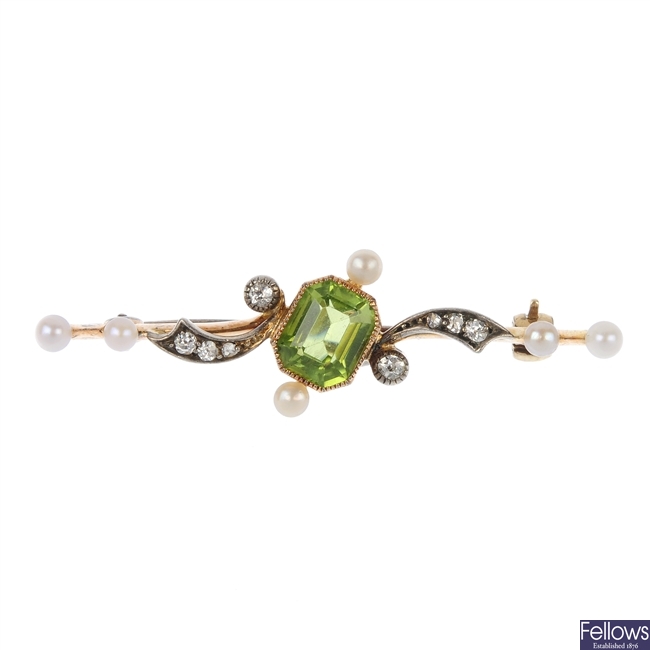 An early 20th century gold peridot, seed pearl and diamond brooch.