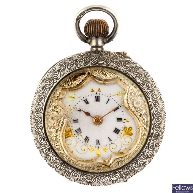 A continental white metal key wind open face pocket watch with a silver fob watch.