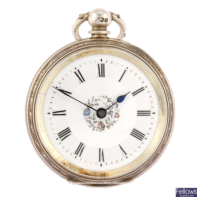 A silver keyless wind open face pocket watch with another pocket watch and chain.