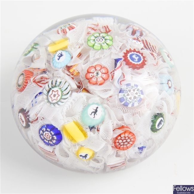 A dated mid 19th century Baccarat spaced millefiori silhouette cane paperweight