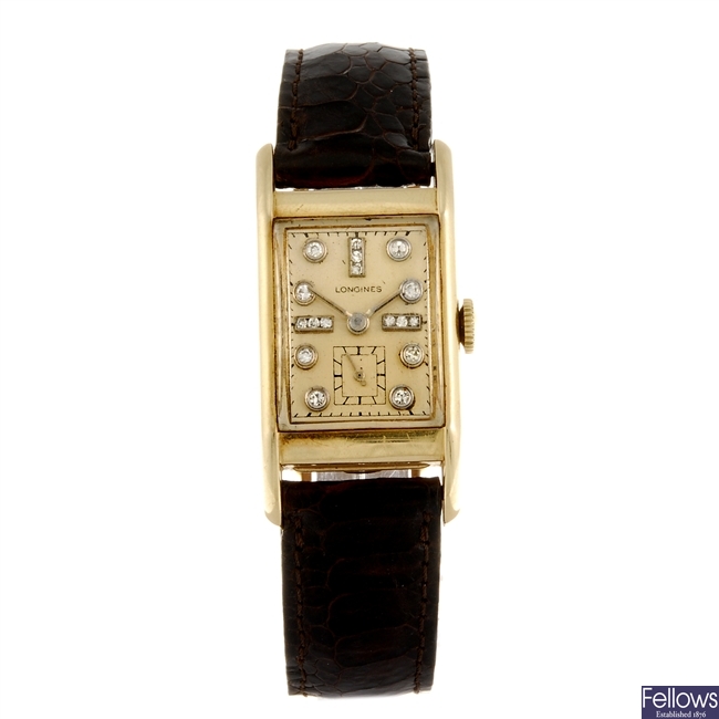 A 14k gold manual wind Longines wrist watch.