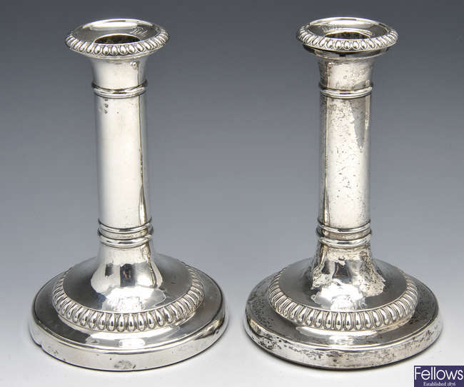 A George III pair of silver candlesticks by John Roberts & Co.