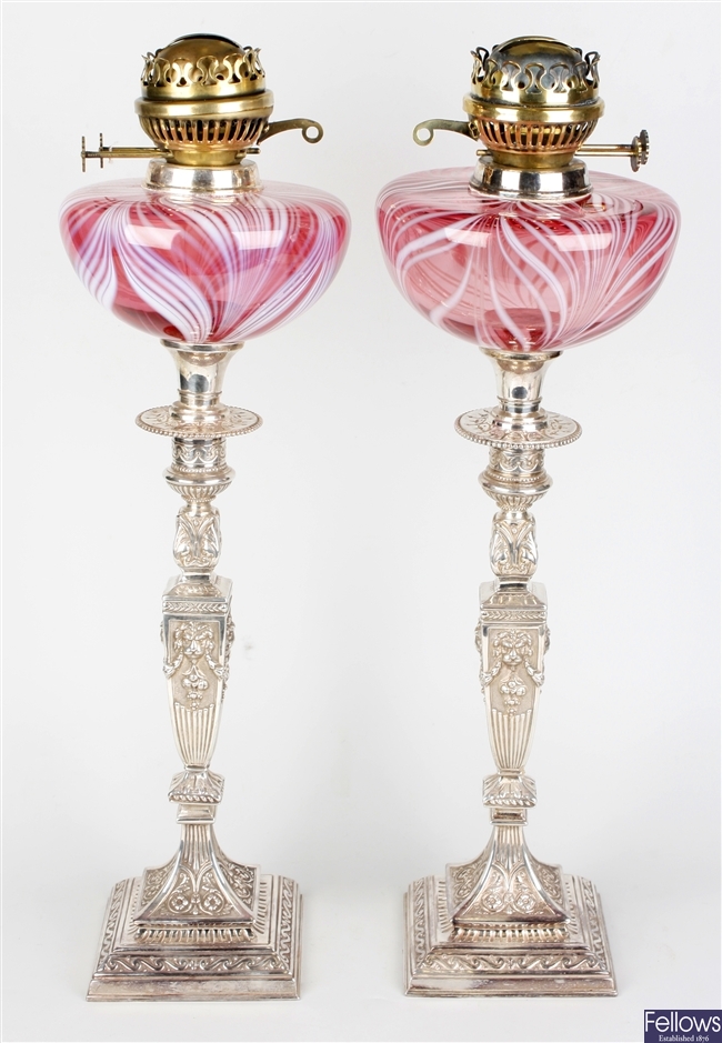 A good pair of silver plated cranberry glass paraffin lamps