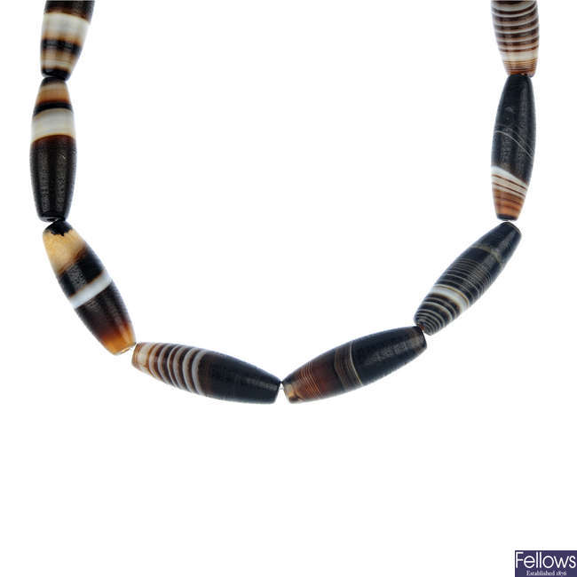 An agate bead necklace and loose bead.