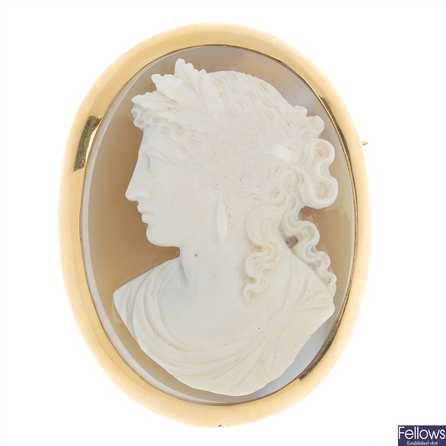 A gold mounted hardstone cameo brooch and cameo ear pendants.