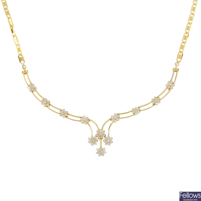 A diamond floral cluster necklace.