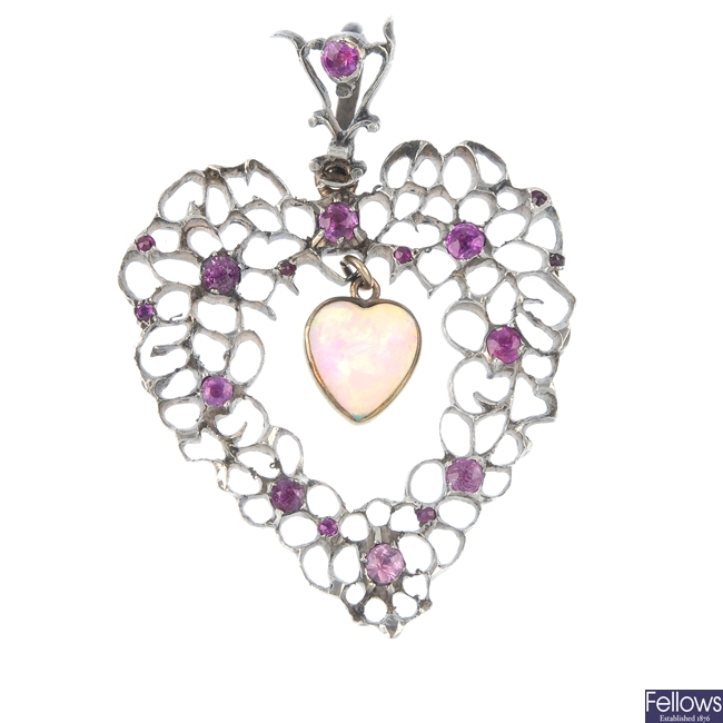 An early 20th century pendant set with pink gems and a later added suspended opal.