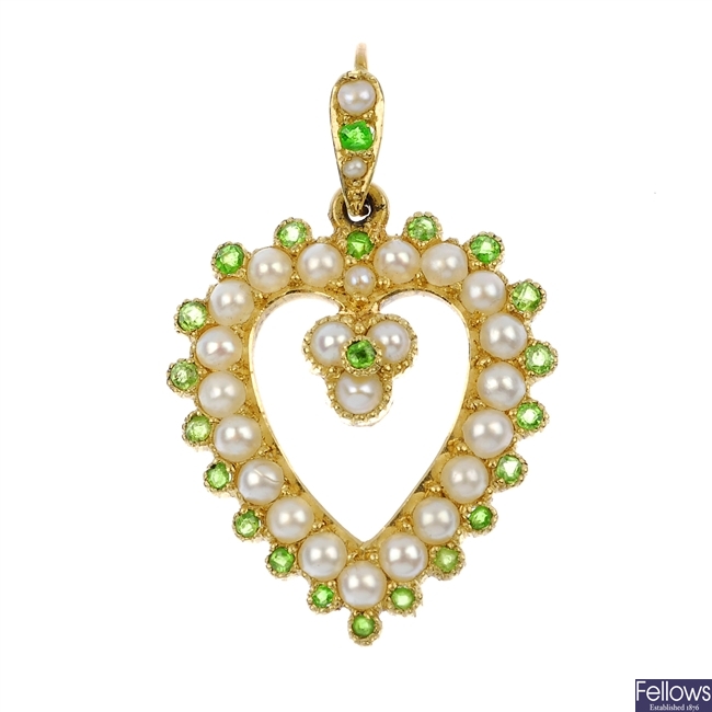 An early 20th century 15ct gold split pearl and demantoid garnet heart-shape pendant.