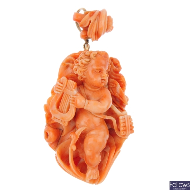 A mid 19th century carved coral cherub pendant.