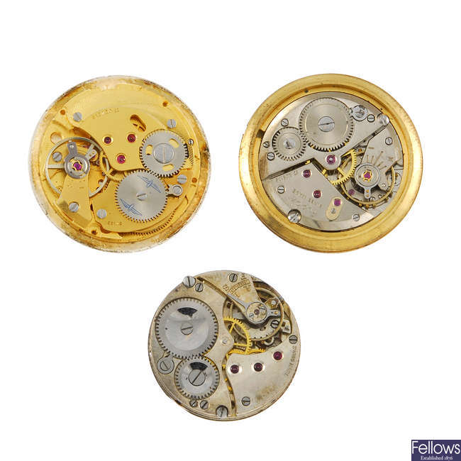 A selection of wrist watch and pocket watch movements in different styles and sizes.