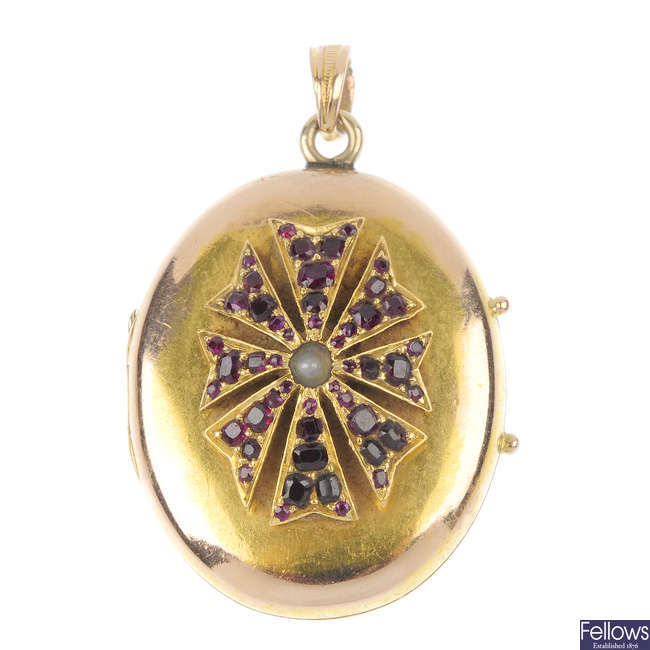 An early 20th century gold ruby and split pearl locket. 