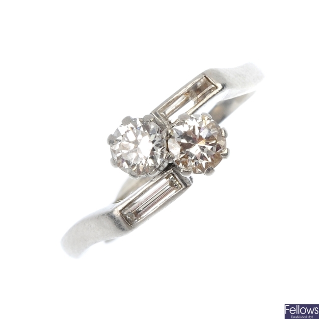 An early 20th century platinum diamond two-stone crossover ring.