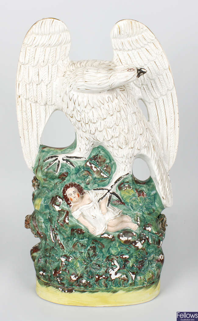 A rare mid Victorian Staffordshire pottery figure group of an eagle and child