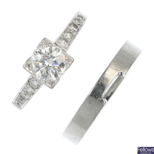 A platinum diamond single-stone ring and a platinum band ring.