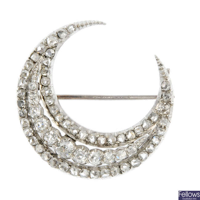 A late 19th century continental silver and gold diamond crescent brooch.
