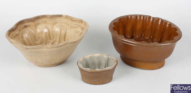A collection of pottery jelly moulds